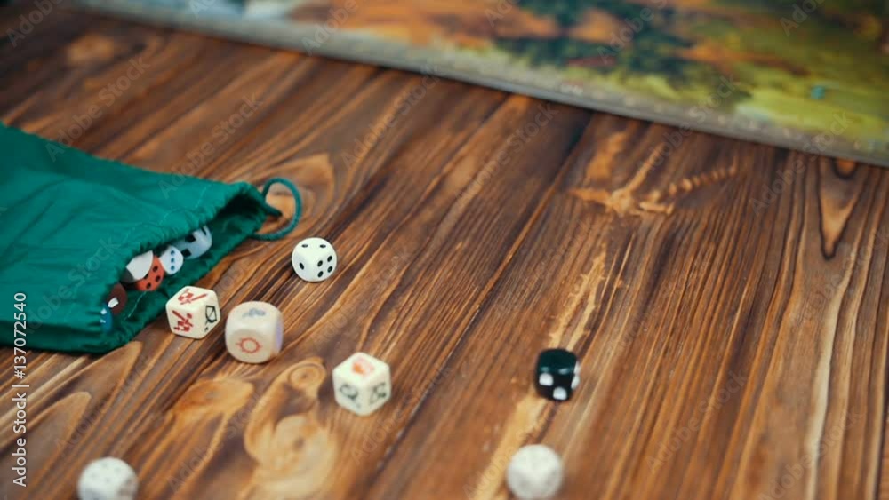 Dices Fall On a Wooden Table From Bag