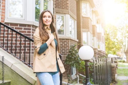 Beautiful woman walking out from home in Toronto photo