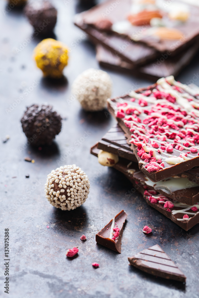 Fototapeta premium Stack of chocolate bars and praline truffle