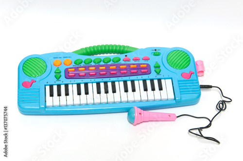 Children toy piano and microphone  on white background.