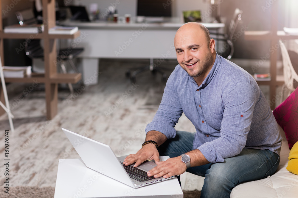 Young businessman working with laptop in office.