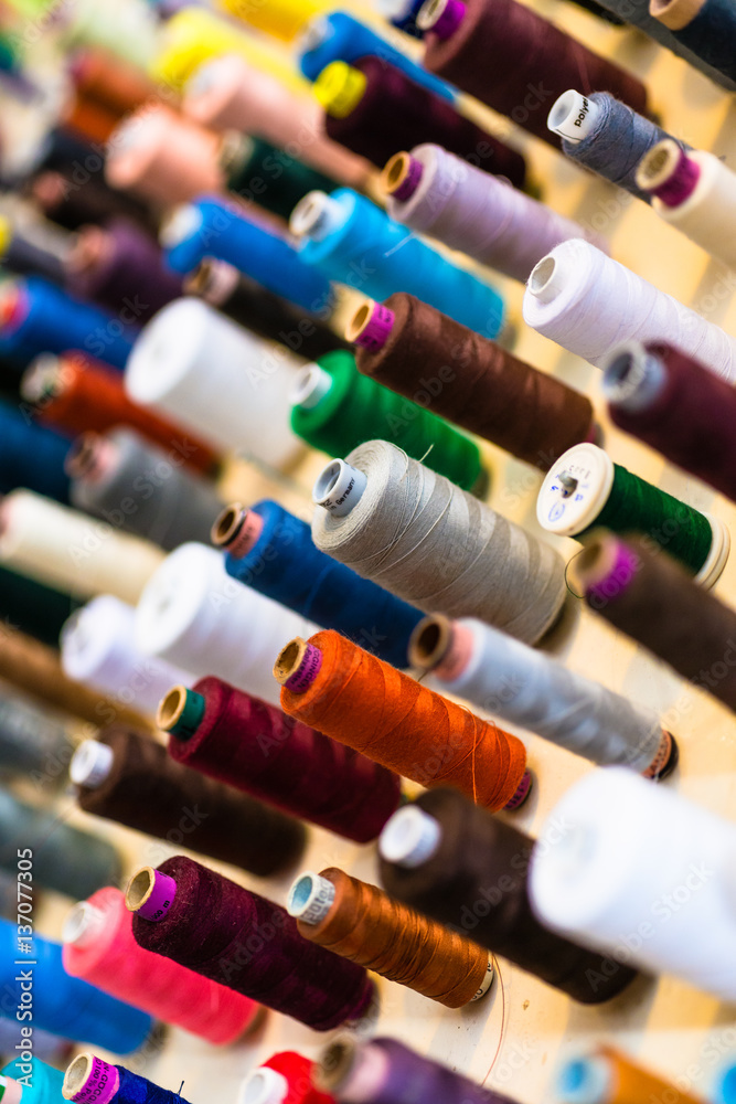 Sewing thread on bobbins in tailor shop Sewing thread on bobbins in tailor shop