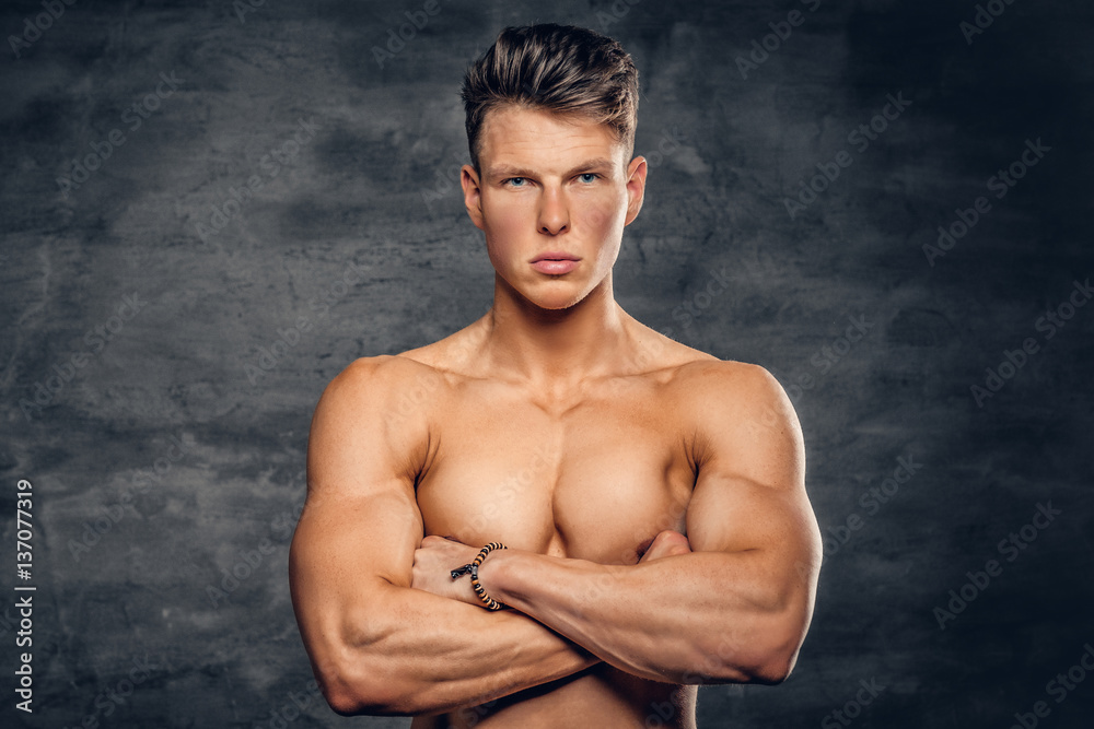 Fototapeta premium Shirtless muscular male on grey background.