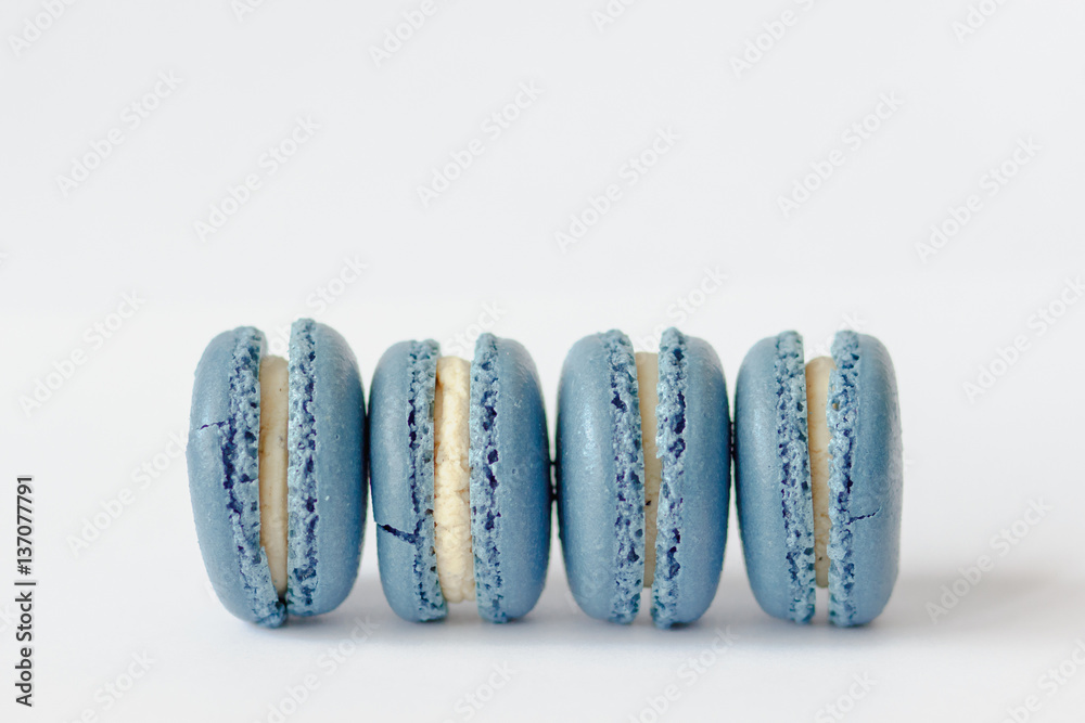 french cookies blue macaroons on a background blue paper french cookies blue macaroons on a background blue paper