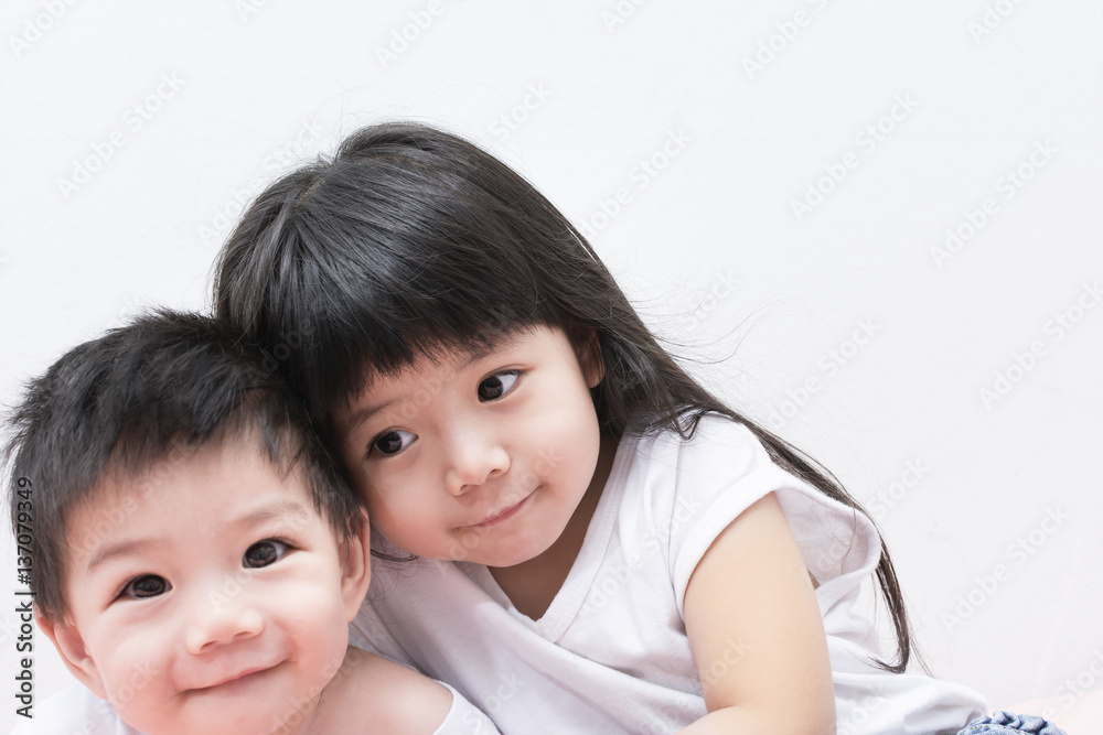 Baby Sister and Brother in White shirt Hugging each other. Baby Sister and Brother in White shirt Hugging each other.