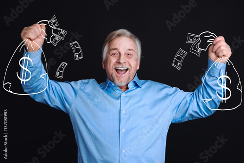 Canvas Print Delighted positive man standing against the black background