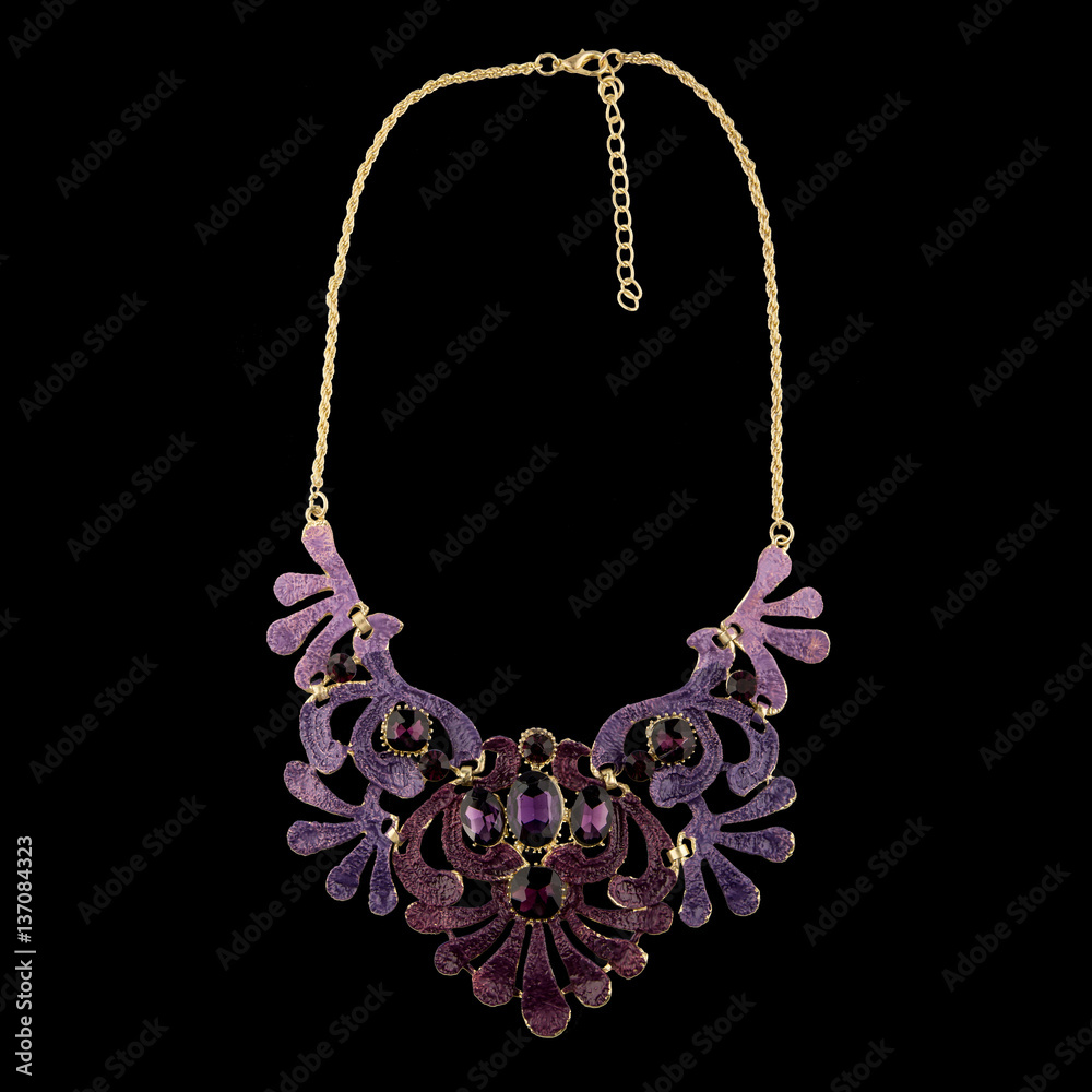 Golden necklace with sapphire on black background Golden necklace with sapphire on black background