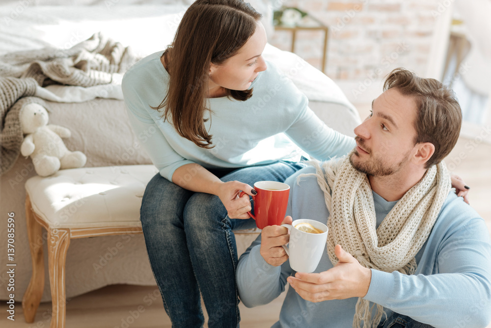 Happy young couple drinking hot tea at home Happy young couple drinking hot tea at home