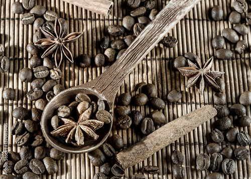 wooden utensils with star anise pepper cinnamon isolated on Mat