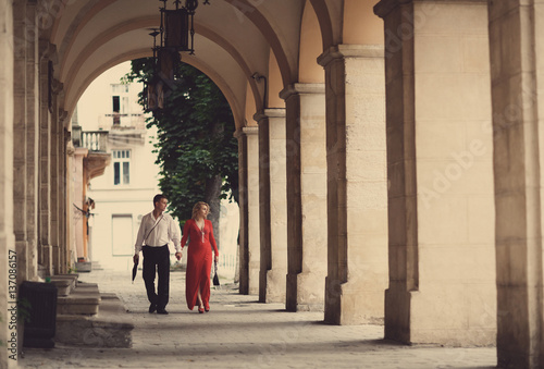 The lovely couple in love walking along corridor