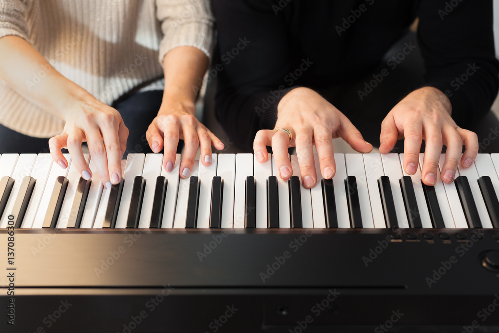 Obraz premium Closeup of hands playing piano. Music and hobby concept