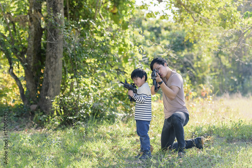 joyful happy Father and son with playing gun in the forest.. © thanatphoto