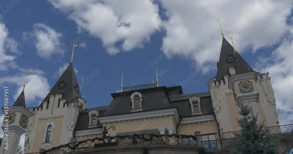 the Fairy Tale Looking Gothic Towers, Narrow Windows, and a Forged Metal Bridge, of Kiev Academic Puppet Tower in Summer the Fairy Tale Looking Gothic Towers, Narrow Windows, and a Forged Metal Bridge, of Kiev Academic Puppet Tower in Summer
