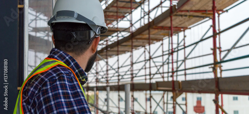 Civil engineer during a site walk checking scaffolding erection photo