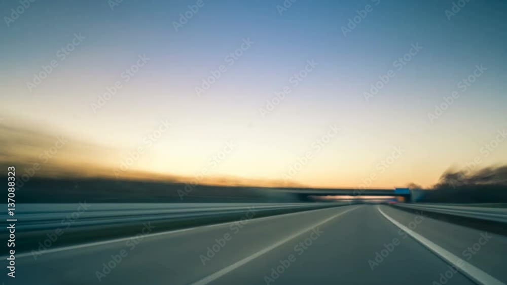 Driving fast on the German Autobahn at sunset, dynamic time lapse video with motion blur