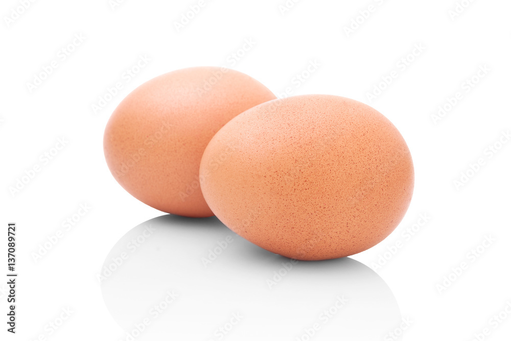 Two brown chicken eggs isolated on white background with shadow reflection. Brown chicken eggs on white background with shadow reflection. Eggs on reflective underlay. Whole eggs on white background. Two brown chicken eggs isolated on white background with shadow reflection. Brown chicken eggs on white background with shadow reflection. Eggs on reflective underlay. Whole eggs on white background.