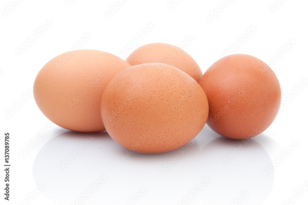 four brown chicken eggs isolated on white background with shadow reflection four brown chicken eggs isolated on white background with shadow reflection