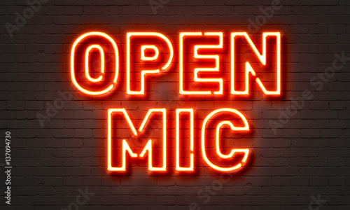 Open mic neon sign on brick wall background. photo