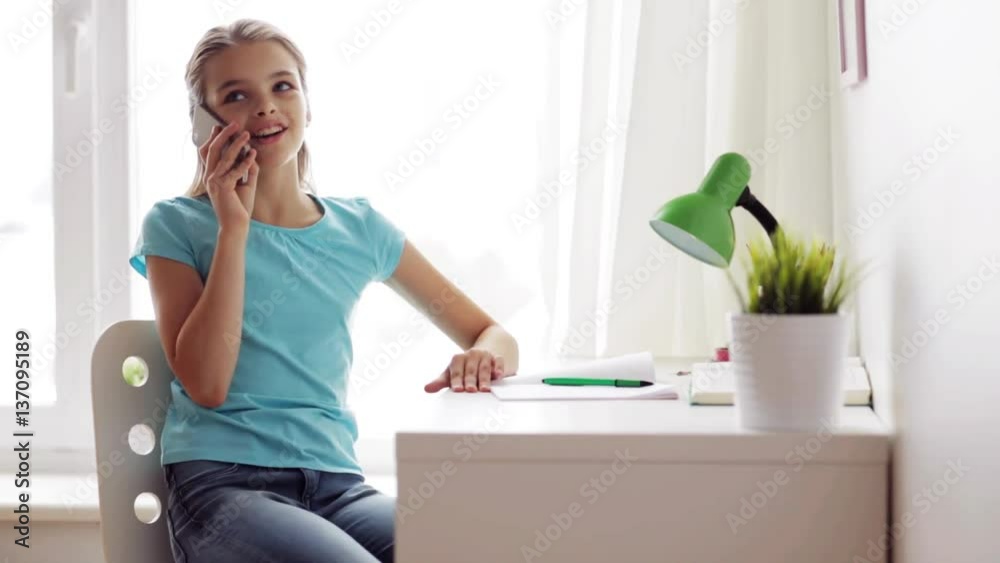 smiling girl calling on smartphone at home