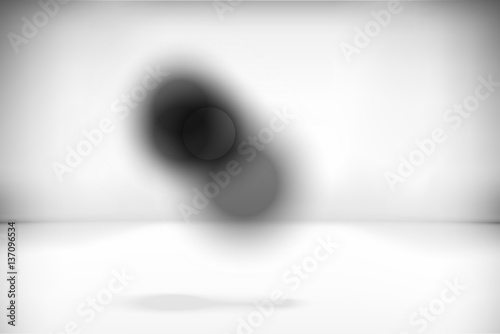 Abstract dark circles in a gray interior room