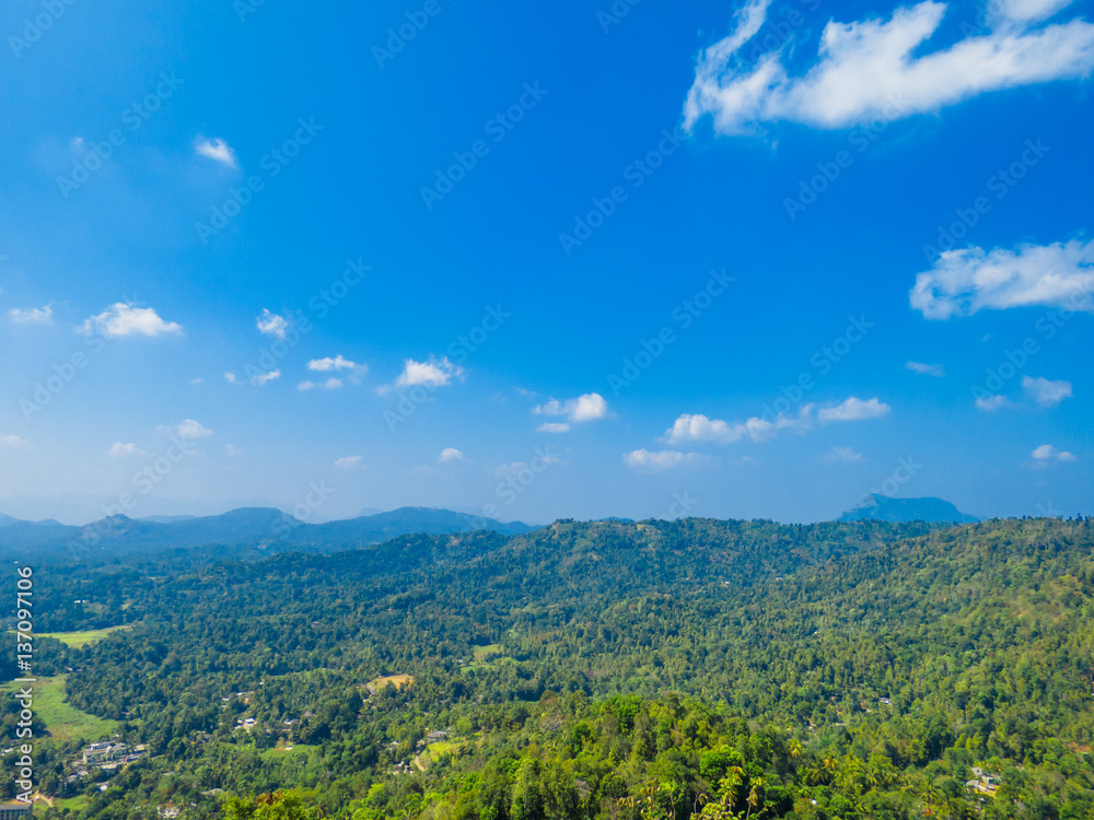 Beautiful Mountain view landscape over greenery with Blue sky and white clouds in Nelligala Kandy, Sri Lanka