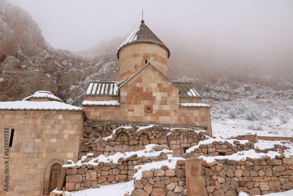 Armenian monastery Noravank - world`s wonder erected in the 13th century. Mysterious winter panorama. The whole monastery covered with fog