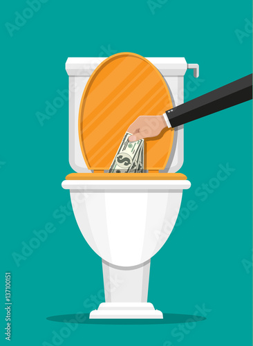 Businessman hand putting dollar bills in toilet