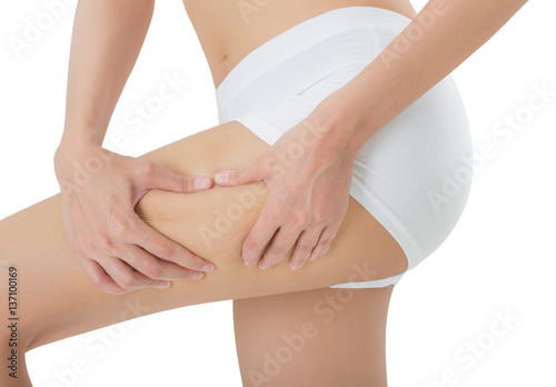 Closeup of a woman's midsection, pinching Excess fat thigh cellulite, overweight concept, Isolated on white background.