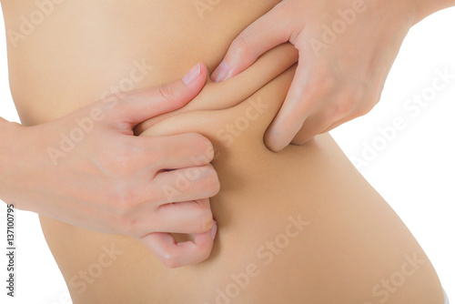 Close up woman checks and pinching Excess fat on her flank seems like to be fat  overweight concept  Isolated on white background.