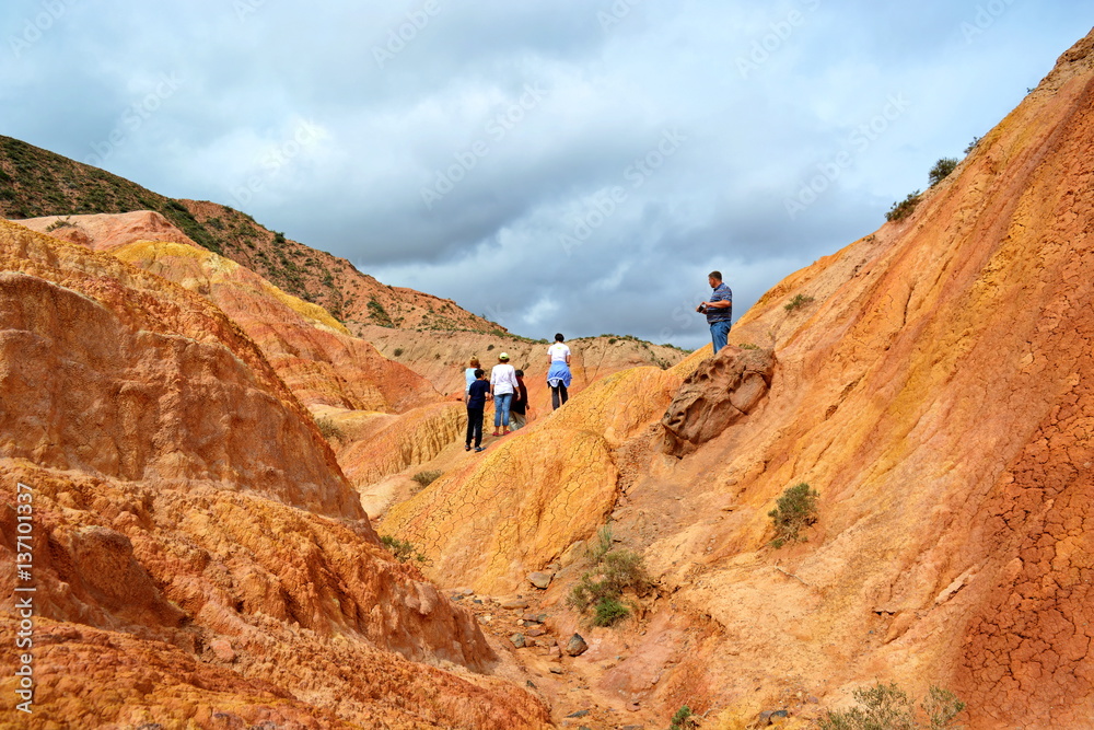 group of tourists in canyon fairy tale, Kyrgyzstan, Issyk-Kul group of tourists in canyon fairy tale, Kyrgyzstan, Issyk-Kul