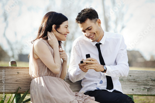 Man proposing to girlfriend on bench