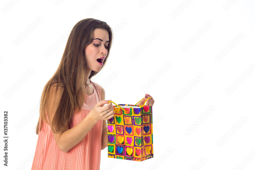 young girl looks at color package and wonders is isolated on white background young girl looks at color package and wonders is isolated on white background