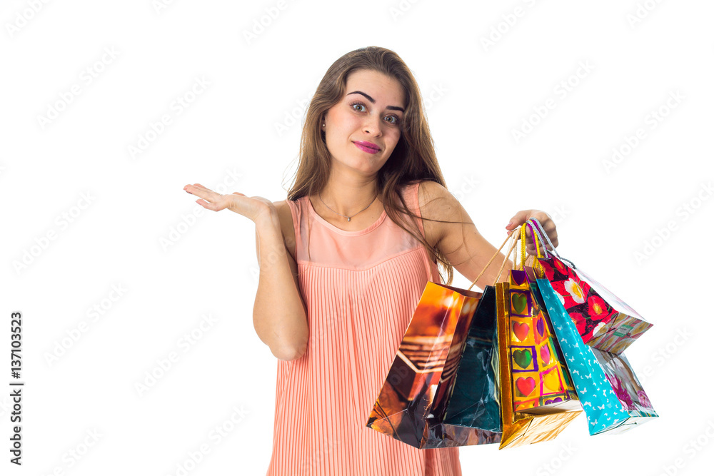 cute girl spreads her hand and holds the multicolored bags isolated on white background cute girl spreads her hand and holds the multicolored bags isolated on white background