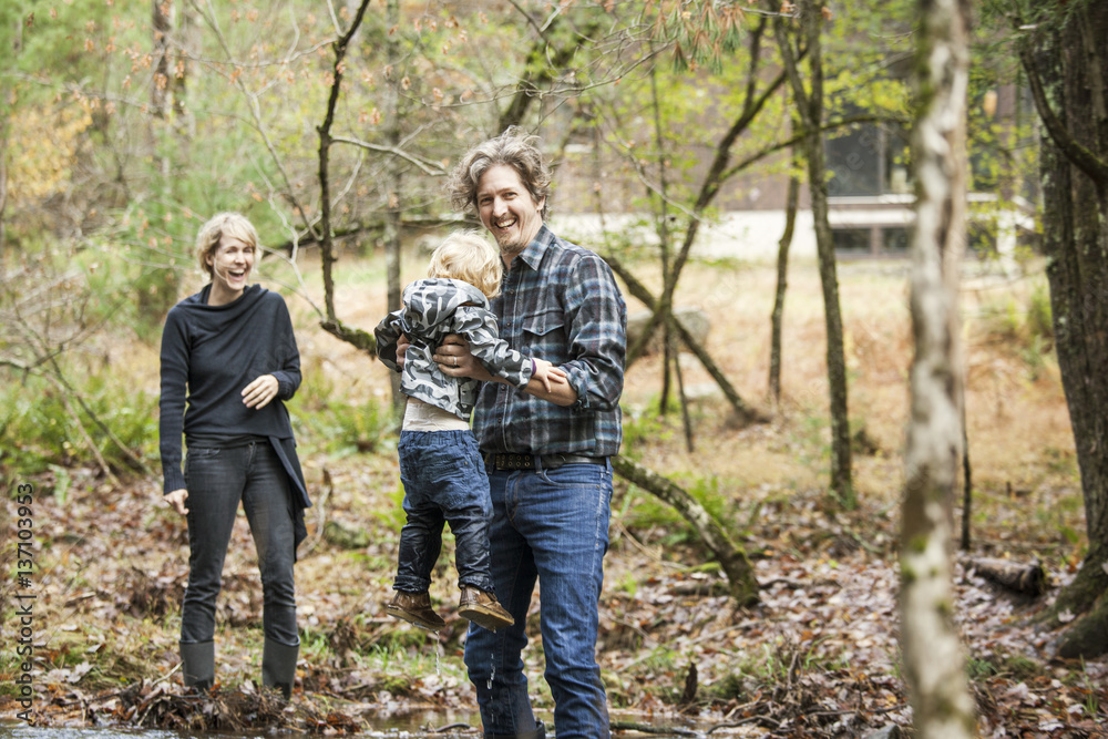 Family with son (18-23 months) standing in forest Family with son (18-23 months) standing in forest