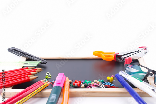 School supplies on chalkboard