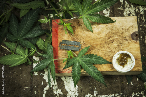 Razor blade and cannabis plants