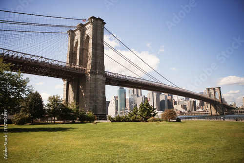 Brooklyn Bridge over east river with city in background photo