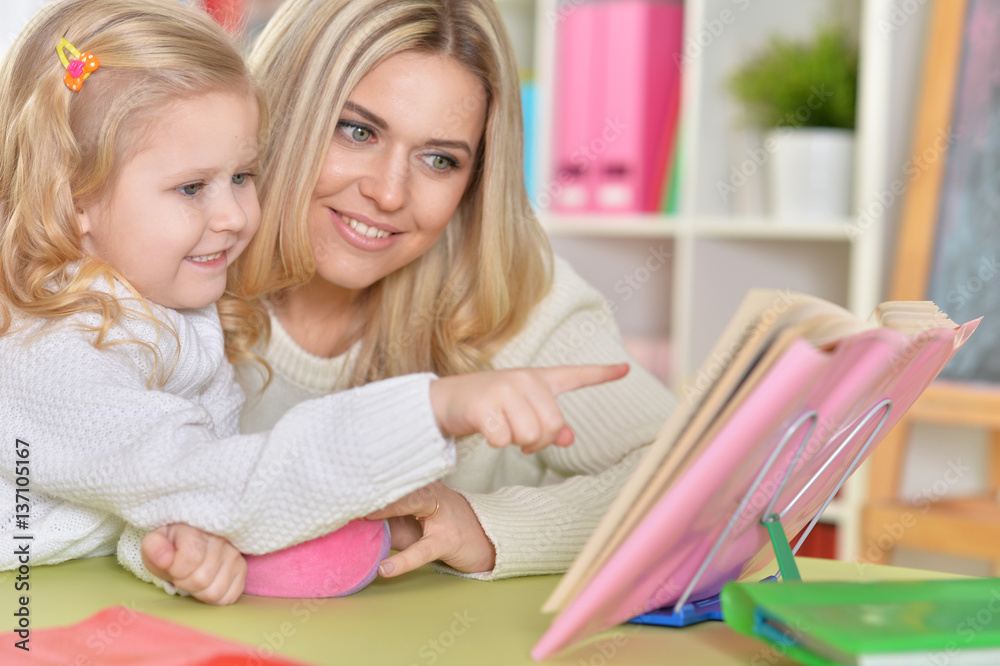 mother with little daughter reading 