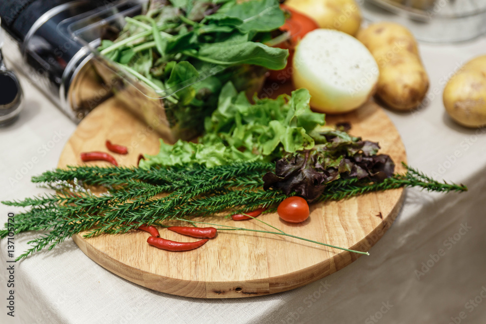 Fresh Ingredients Include Rosemary, Onion, Tomato, Potato and Vegetables on Wood Block. Fresh Ingredients Include Rosemary, Onion, Tomato, Potato and Vegetables on Wood Block.