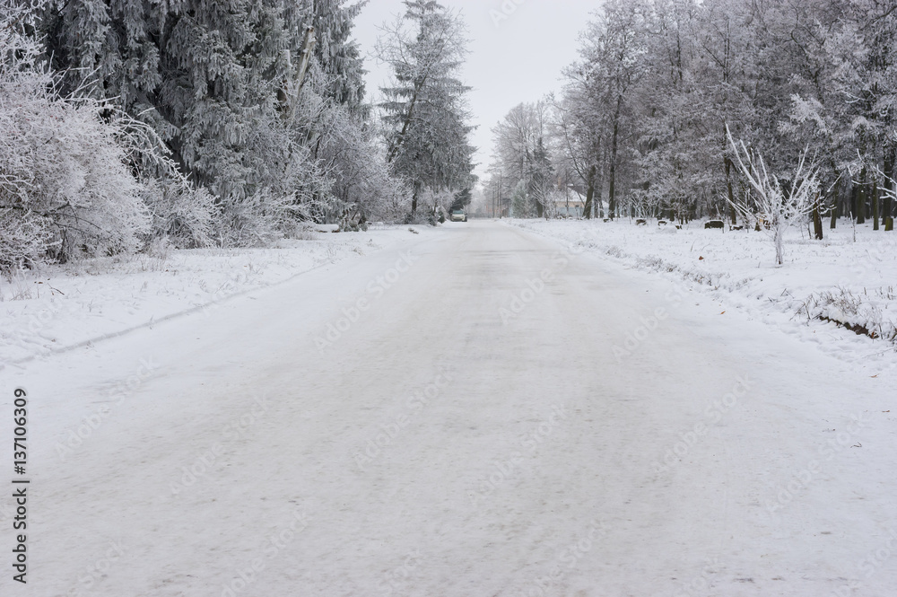 Snowy street of small village in central Ukraine at winter season