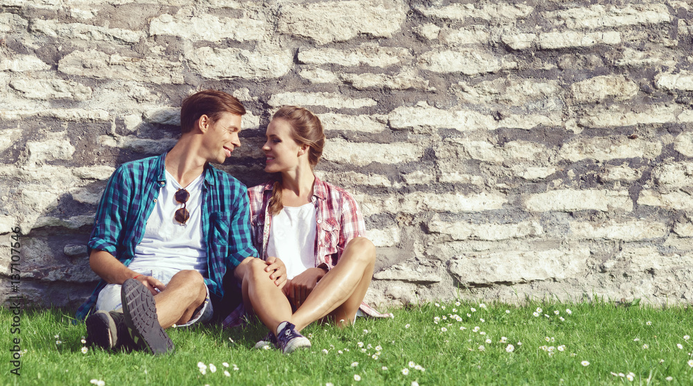 Beautiful couple of hipsters having a date in park. Love, relationship, romance concept. Beautiful couple of hipsters having a date in park. Love, relationship, romance concept.