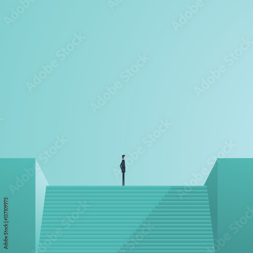 Businessman standing on top of stairs as a symbol of business leadership, career success, ambition and achievement.