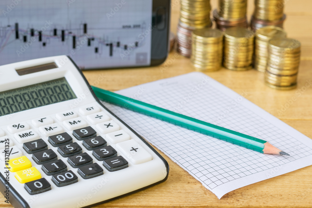 Metal coins and calculator on a rustic table. Metal coins and calculator on a rustic table.