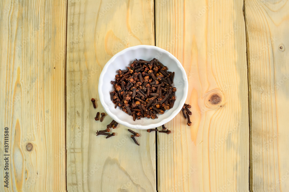 Cloves : Spice in bowl on texture wooden background Cloves : Spice in bowl on texture wooden background
