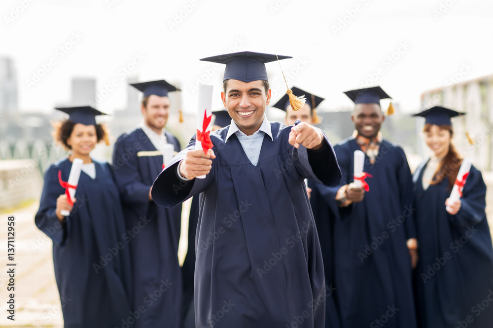 happy student with diploma pointing finger at you happy student with diploma pointing finger at you