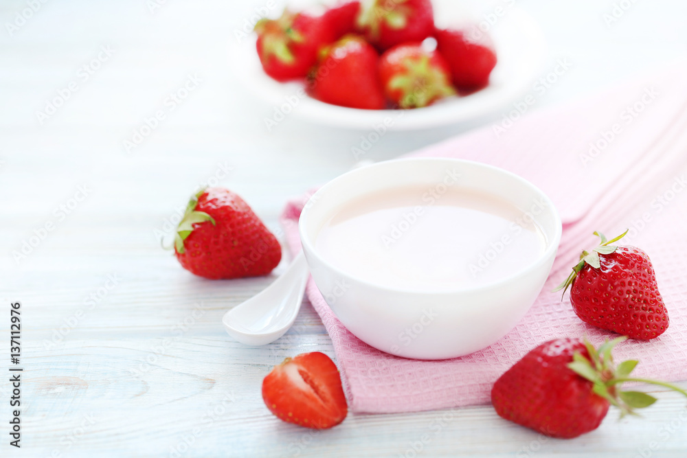 Strawberry yogurt in bowl on wooden table Strawberry yogurt in bowl on wooden table