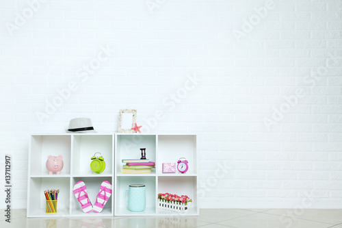 White shelves on a brick wall background © 5second