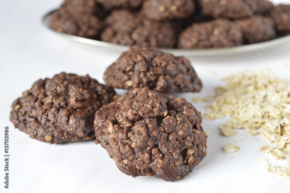 Homemade double chocolate oatmeal cookies with scattered oat flakes Homemade double chocolate oatmeal cookies with scattered oat flakes