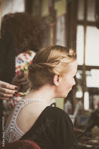 woman making braids at hair studio