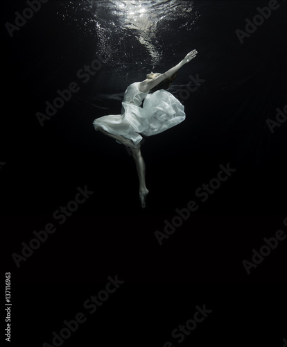 Print op canvas Young female ballet dancer dancing underwater